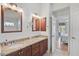 Bathroom boasts double sinks with granite counters and wood cabinets at 4969 Creekside Trl, Sarasota, FL 34243