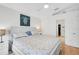 Bright bedroom features a queen bed, a ceiling fan and an ensuite bathroom at 4969 Creekside Trl, Sarasota, FL 34243