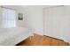 Simple bedroom with hardwood floors, natural light from a window, and a closet at 4969 Creekside Trl, Sarasota, FL 34243