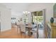 Bright dining area with wood floors, stylish furniture, and sliding glass doors to the outdoors at 4969 Creekside Trl, Sarasota, FL 34243