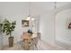 Bright kitchen nook with round table, three chairs and a view of the kitchen at 4969 Creekside Trl, Sarasota, FL 34243