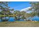 Beautiful lake view, framed by trees, shows other houses on opposite shore at 4969 Creekside Trl, Sarasota, FL 34243