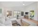 Bright living room featuring a vaulted ceiling, large windows, and comfortable white sofa, creating a welcoming atmosphere at 4969 Creekside Trl, Sarasota, FL 34243