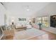 Spacious living room with vaulted ceiling, white sofa, wood floors and natural light at 4969 Creekside Trl, Sarasota, FL 34243