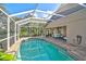 Enclosed pool area featuring clear water, brick decking, and a relaxing outdoor space at 4969 Creekside Trl, Sarasota, FL 34243