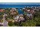 Stunning waterfront estate featuring a private boat dock and lush tropical landscaping at 500 Harbor Point Rd, Longboat Key, FL 34228