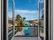 Balcony view overlooking the pool, palm trees, and waterfront at 500 Harbor Point Rd, Longboat Key, FL 34228