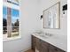 Stylish bathroom with a modern vanity, marble countertop, elegant mirror, and decorative lighting at 500 Harbor Point Rd, Longboat Key, FL 34228