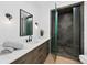 Modern bathroom featuring a quartz countertop, dark wood cabinets, and glass-enclosed shower at 500 Harbor Point Rd, Longboat Key, FL 34228