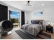 Fun bedroom with a black accent wall and a metal chair near balcony at 500 Harbor Point Rd, Longboat Key, FL 34228