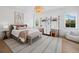 Cozy bedroom with a chandelier, textured rug, and custom shelving for stylish storage at 500 Harbor Point Rd, Longboat Key, FL 34228