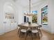 Bright dining room with bay windows, modern chandelier, and hardwood floors at 500 Harbor Point Rd, Longboat Key, FL 34228