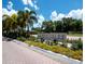 An inviting entrance sign reads 'Bay Isles North Longboat Key Club' framed by colorful flowers and palm trees at 500 Harbor Point Rd, Longboat Key, FL 34228