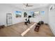 Bright exercise room featuring hardwood floors, large windows, and modern equipment at 500 Harbor Point Rd, Longboat Key, FL 34228