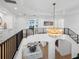 Bright foyer with an elegant chandelier, staircase, and a glimpse of the ocean view at 500 Harbor Point Rd, Longboat Key, FL 34228