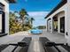 Resort-style pool area with lounge chairs, lush landscaping, and beautiful waterfront views at 500 Harbor Point Rd, Longboat Key, FL 34228