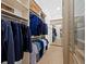 Organized walk-in closet featuring custom shelving, hanging racks, and a full-length mirror at 500 Harbor Point Rd, Longboat Key, FL 34228