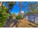 Landscaped backyard with mature trees and a wooden fence at 5041 Barrington Cir # 802, Sarasota, FL 34234