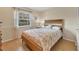 Bright bedroom featuring a coral-colored comforter and wood-framed bed at 5041 Barrington Cir # 802, Sarasota, FL 34234