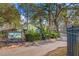 Gated Barrington Woods community entrance with lush landscaping at 5041 Barrington Cir # 802, Sarasota, FL 34234