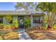 Front view of a green house with walkway and landscaping at 5041 Barrington Cir # 802, Sarasota, FL 34234