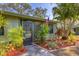 Well-maintained home featuring colorful landscaping and a sidewalk leading to the front door at 5041 Barrington Cir # 802, Sarasota, FL 34234