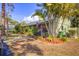 Single-story house with lush landscaping and American flag at 5041 Barrington Cir # 802, Sarasota, FL 34234