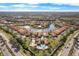 Aerial view of a neighborhood featuring stunning homes, gorgeous landscaping and a beautiful pond with fountains at 5155 Cantabria Crest, Sarasota, FL 34238