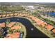 Aerial view showcasing homes around a picturesque lake with fountains in a well-planned community at 5155 Cantabria Crest, Sarasota, FL 34238