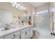 Bathroom featuring a large single sink vanity, and a glass enclosed tub and shower at 5155 Cantabria Crest, Sarasota, FL 34238