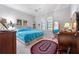 This bedroom features a ceiling fan, plantation shutters, and is decorated with neutral colors at 5155 Cantabria Crest, Sarasota, FL 34238