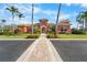 Attractive clubhouse featuring stucco architecture, a tile roof, and a brick-paved walkway surrounded by landscaping at 5155 Cantabria Crest, Sarasota, FL 34238