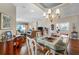 Formal dining area featuring hardwood floors, modern lighting, and views of the living room and backyard at 5155 Cantabria Crest, Sarasota, FL 34238