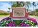 Elegant entrance sign for The Vineyards at Silver Oak, surrounded by colorful flowers and lush greenery at 5155 Cantabria Crest, Sarasota, FL 34238