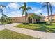 Attractive single-story home featuring well-kept landscaping, a tile roof, and a spacious two-car garage at 5155 Cantabria Crest, Sarasota, FL 34238