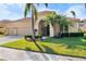 Beautiful single-story home showcasing lush landscaping, a tile roof, and a convenient two-car garage at 5155 Cantabria Crest, Sarasota, FL 34238