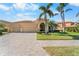 Inviting single-story home with well-maintained landscaping, a tile roof, and an attached two-car garage at 5155 Cantabria Crest, Sarasota, FL 34238