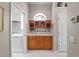 Hallway with a built-in wet bar with cabinets, and view of a laundry area at 5155 Cantabria Crest, Sarasota, FL 34238