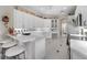 Well-lit kitchen with white cabinetry, granite countertops, and modern stainless steel appliances at 5155 Cantabria Crest, Sarasota, FL 34238