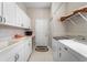 Laundry room featuring a white sink, white cabinets, and a white washer and dryer at 5155 Cantabria Crest, Sarasota, FL 34238