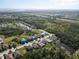 Aerial view of a residential area, showcasing the home's location near a pond and green spaces at 5718 Broad River Run, Ellenton, FL 34222