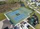 Aerial view of community amenities: tennis courts, a basketball court, and a playground at 5718 Broad River Run, Ellenton, FL 34222