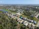 Expansive aerial shot of the residential community, featuring numerous homes and recreational water areas at 5718 Broad River Run, Ellenton, FL 34222