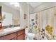 Bathroom with a neutral-toned shower curtain, vanity, and fixtures at 5718 Broad River Run, Ellenton, FL 34222