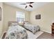 Bedroom with two twin beds, ceiling fan, and lots of natural light at 5718 Broad River Run, Ellenton, FL 34222