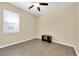 A bright, empty bedroom featuring laminate flooring, a ceiling fan and ample natural light at 5718 Broad River Run, Ellenton, FL 34222