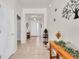 Bright foyer with tile flooring, neutral walls, and decorative accents leading to a well-lit entrance at 5718 Broad River Run, Ellenton, FL 34222