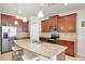 Kitchen featuring rich wood cabinets, granite countertops, and stainless steel appliances at 5718 Broad River Run, Ellenton, FL 34222