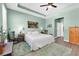 Spacious main bedroom features a tray ceiling and a ceiling fan at 5718 Broad River Run, Ellenton, FL 34222