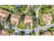 Aerial view of a property with tile roof, green lawn and mature trees, perfect for outdoor enjoyment at 5718 Garden Lakes Palm, Bradenton, FL 34203